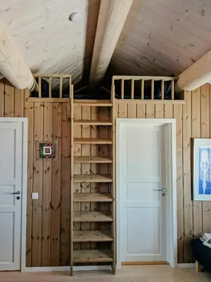 a room with a bunk bed with wooden walls at Mountain Cabin With Views Over Storevann in Hemsedal