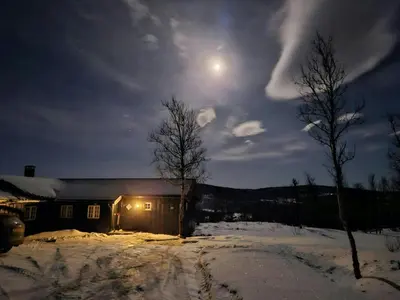 a house in the snow at night with the moon at Mountain Cabin With Views Over Storevann in Hemsedal