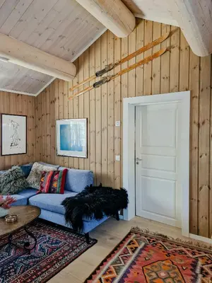 a living room with a blue couch and a door at Mountain Cabin With Views Over Storevann in Hemsedal