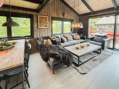 a living room with a couch and a table at Spacious Apartment By Hardangervidda National Park in Ustaoset