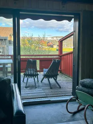 two chairs sitting on a porch with a view of a yard at Spacious Apartment By Hardangervidda National Park in Ustaoset