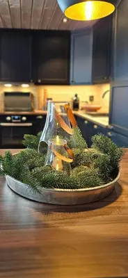 a christmas centerpiece on a table in a kitchen at New Cabin With Panoramic Views Of Lake Osen