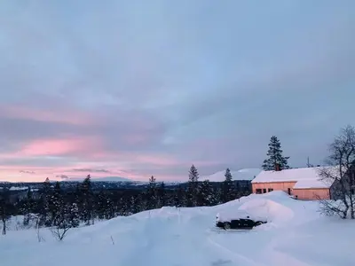 a car buried in snow in front of a barn at Modern Cabin With Views Of Trysil Mountain in Trysil