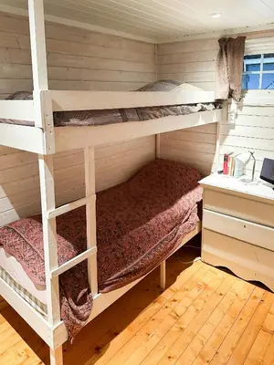 a bedroom with two bunk beds in a cabin at Family Cabin With Charm in Mesnali