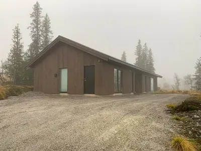 a large wooden building on a dirt road at Modern Cabin Close To The Ski Slopes In Haglebu in Eggedal