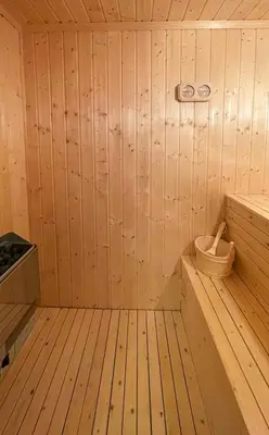 a wooden sauna with a tub and a toilet at Family Cabin In Rauland in Rauland