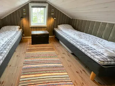two beds in a room with a rug at Family Cabin In Rauland in Rauland