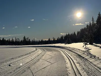 a snow covered road with tire tracks in the snow at Modern Cabin With Views Of Skeikampen in Svingvoll