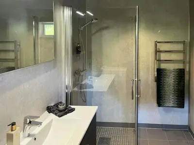 a bathroom with a shower and a sink and a shower at Modern Cabin With Views Of Skeikampen in Svingvoll