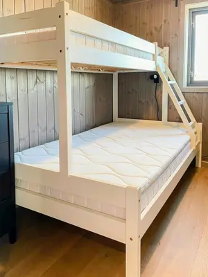 two bunk beds in a room with wooden walls at Cabin With Views Over Hafjell And Gausdal in Svingvoll