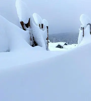 a pile of snow on top of a house at Cabin With Views Over Hafjell And Gausdal in Svingvoll