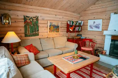 a living room with a couch and a table at Traditional Log Cabin At Reineskarvet in Ål