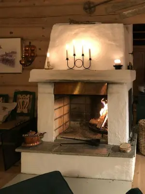 a fireplace with candles and a fire in it at Traditional Log Cabin At Reineskarvet in Ål