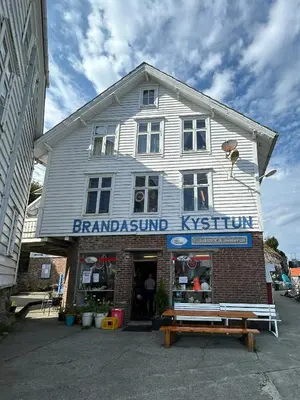 a large white building with a sign on it at Architect-Designed Cabin Panoramic View in Ervik