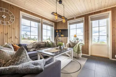 a living room with a couch and a table at Mountain Apartment By Trysil's Best Bike Trails in Trysil