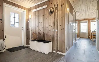 a hallway with wooden walls and a bench in a room at Mountain Apartment By Trysil's Best Bike Trails in Trysil