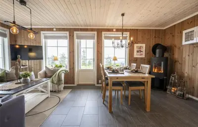 a living room with a table and a dining room at Mountain Apartment By Trysil's Best Bike Trails in Trysil