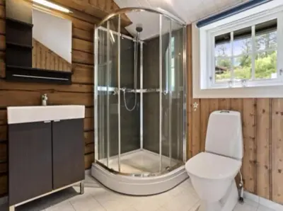 a bathroom with a shower and a toilet and a sink at Timber Cabin With Soul At Kvamskogen in Norheimsund