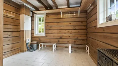 a room with wooden walls and a bench in it at Timber Cabin With Soul At Kvamskogen in Norheimsund