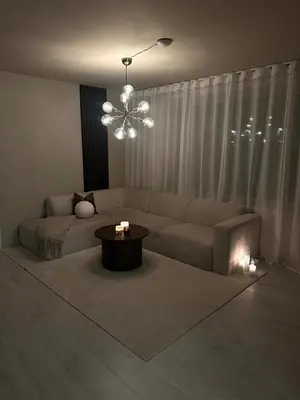 a living room with a couch and a table at Elegant city apartment in Bergen- Private outdoor patio and free parking in Bergen