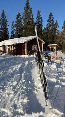 a pair of skis in the snow in front of a cabin at Idyllic house in Hurdal 2 bedroom in Hurdal