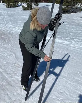 a woman is holding skis in the snow at Idyllic house in Hurdal 2 bedroom in Hurdal