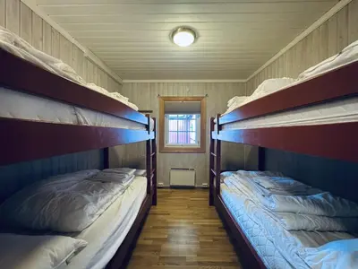 a room with two bunk beds in a house at Red Cross Cabin, Spacious mountain lodge in Gol