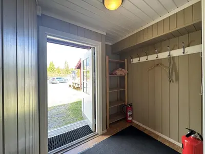 a small room with a door leading to a garage at Red Cross Cabin, Spacious mountain lodge in Gol