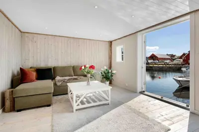 a living room with a couch and a table at Raffelbrygga in Bud