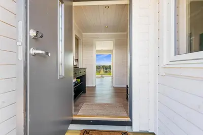 a door leading into a home with a hallway at Ny feriehytte i skjærgården in Austevoll