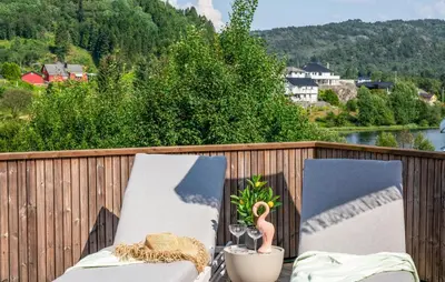 a balcony with two chairs and a pink flamingo on it at Luxurious Home In Ytre Arna With Wifi in Ytre Arna