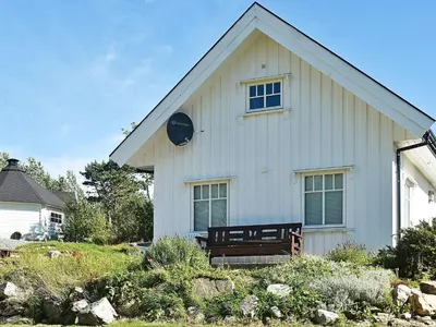 a white house with a bench in front of it at 5 person holiday home in Oksvoll in Oksvoll