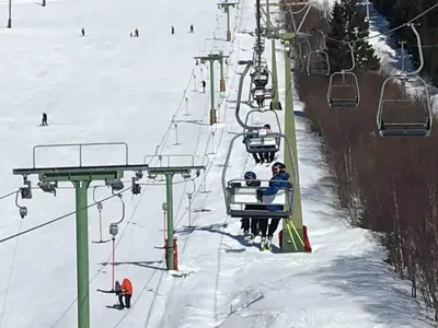 a group of people riding a ski lift in the snow at Great cabin in beautiful nature in Ørsta