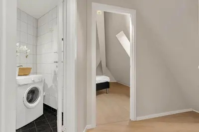 a bathroom with a washer and dryer in a room at 307SB10 - Three Bedroom Stay in Bergen