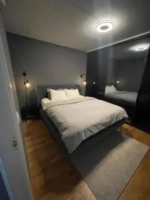 a bedroom with a large bed in a room at Modern apartment in the middle of Bergen city center in Bergen