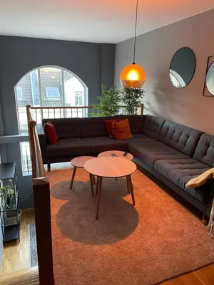 a living room with a couch and a table at Modern apartment in the middle of Bergen city center in Bergen