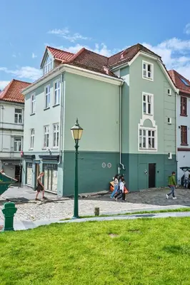 a group of people walking in front of buildings at HD Central Topfloor in Bergen