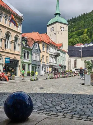 a large blue ball sitting on a cobblestone street at HD Central Topfloor in Bergen