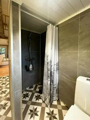 a bathroom with a shower with a shower curtain at Restored Farmhouse By The Sea In Kvalheim in Raudeberg