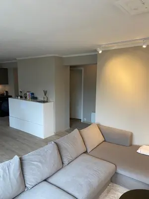 a living room with a large couch in a room at Great and modern apartment at Grilstad Marina! in Trondheim