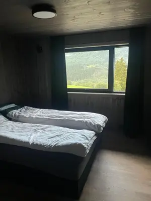a bedroom with a bed in front of a window at Flott hytte i Sogndal skisenter-Hodlekve in Sogndal