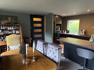a kitchen with a table and chairs and a counter at Fossen Bratte Mountain home in Eikedalen