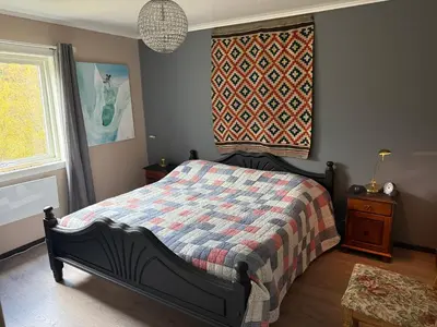 a bedroom with a bed and a window at Fossen Bratte Mountain home in Eikedalen