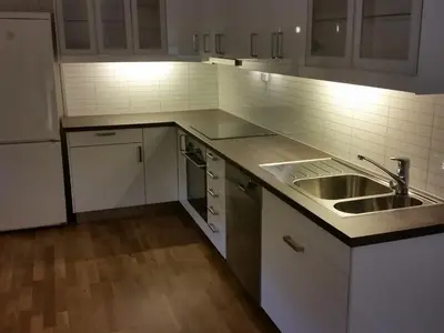 a kitchen with white cabinets and a sink and a counter at Sentrumsvegen 28, GOL in Gol