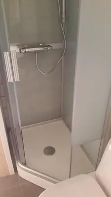 a shower with a glass door with a drain at Sentrumsvegen 28, GOL in Gol