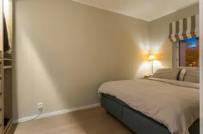 a bedroom with a large bed and a window at J og F in Bergen