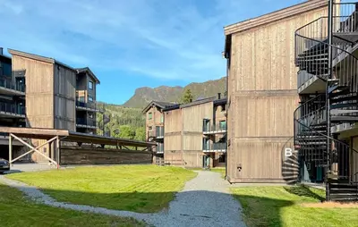 a group of buildings next to a grassy field at 3 Bedroom Awesome Apartment In Hemsedal in Hemsedal