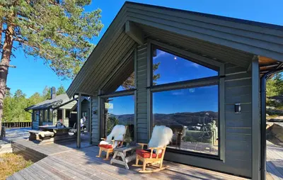 a cabin with large windows on a deck at 5 Bedroom Stunning Home In Eggedal in Eggedal