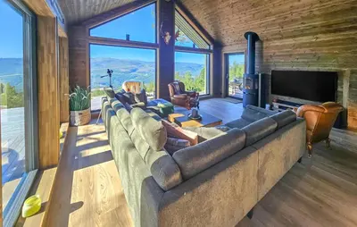 a living room with a large couch and a television at 5 Bedroom Stunning Home In Eggedal in Eggedal