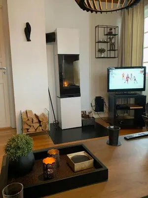 a living room with a television and a table at Central on Beitostølen with walking distance to everything in Beitostøl